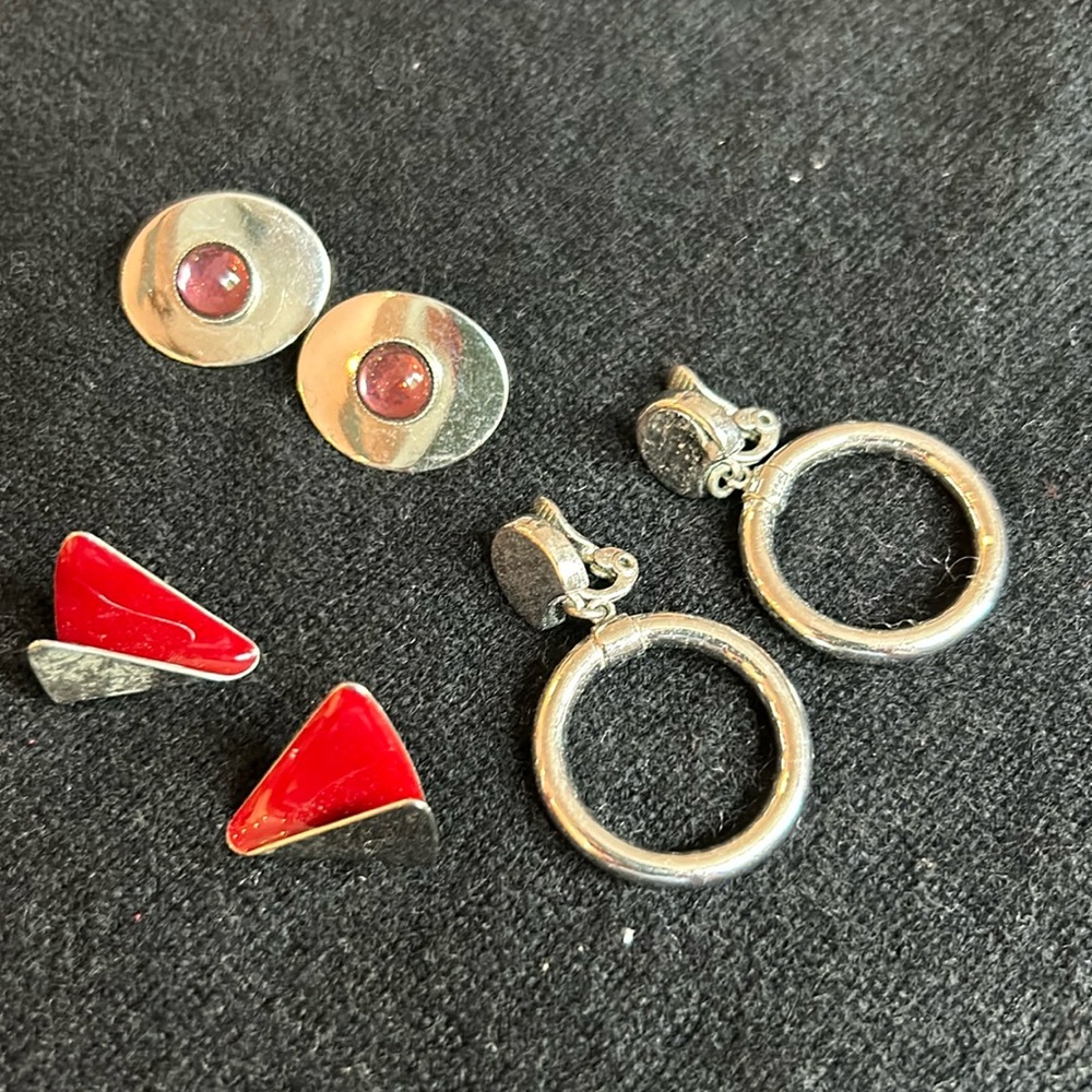3 pairs of silver earrings. (One set is clip-on)